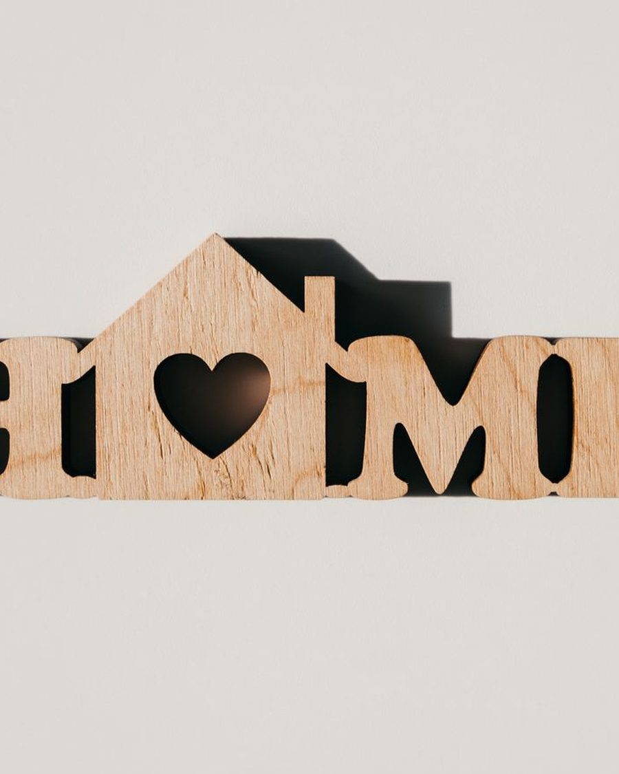 Laser-cut wooden HOME sign with a heart