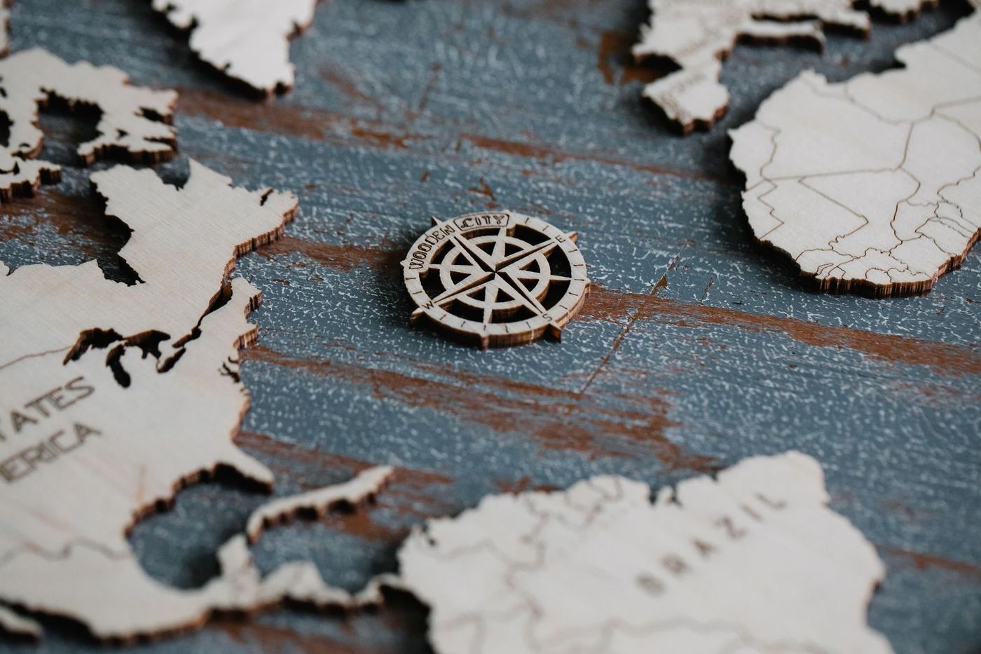 Laser-cut wooden world map with a compass rose
